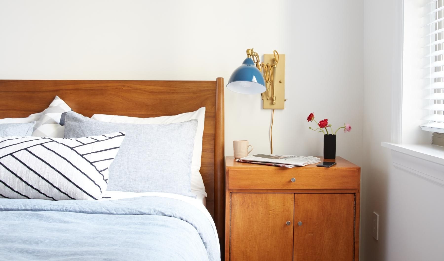 Relax and recharge in beautiful and spacious bedrooms a bed with a lamp on it