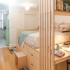 a bunk bed in a bedroom with a desk